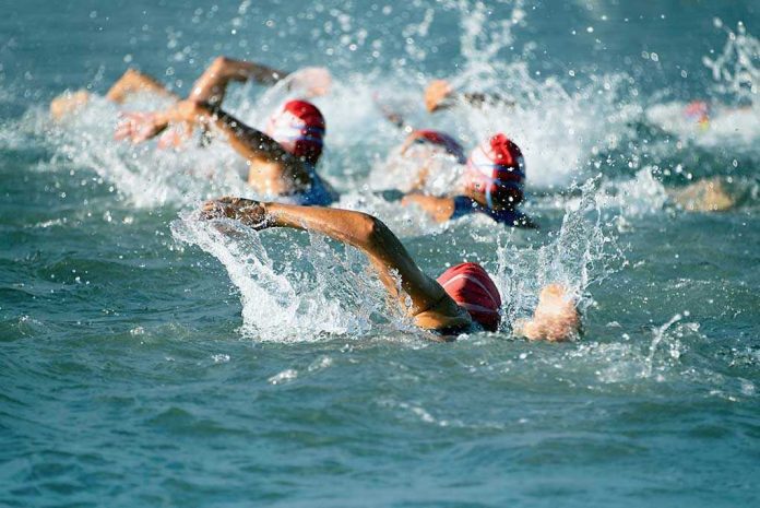 Group of swimmers racing in open water.