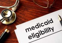 Stethoscope pen document about Medicaid eligibility on table