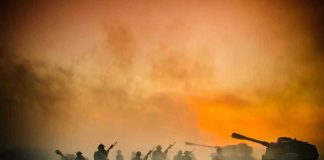 Soldiers and tanks in the foggy battlefield.