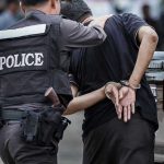 Judge SLAMS Prosecutors: Maduro Charges Crumbling Police officer arrests handcuffed person.