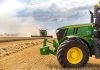 John Deere’s $70M U.S. Investment Sparks Industrial Boom A green tractor in a wheat field.