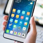 Yearly Screen Time Shocker: Users Confront Reality A person holding a smartphone displaying various mobile applications