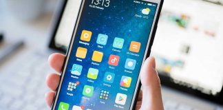 Yearly Screen Time Shocker: Users Confront Reality A person holding a smartphone displaying various mobile applications