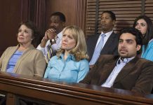 A diverse group of jury members sitting in a courtroom with serious expressions