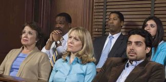 A diverse group of jury members sitting in a courtroom with serious expressions