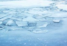 Heartbreaking Loss: 3 Brothers Drown in Icy Tragedy A frozen lake with cracked ice and blue hues