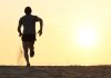 Silhouette of a man running on the beach during sunset
