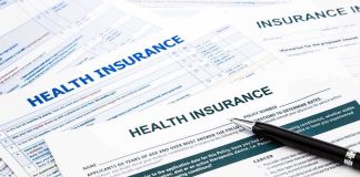 Health Insurance Premiums Spike: 22 Million Americans Hit Hard Close-up of health insurance application forms with a pen
