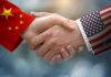 Chinese Spy ORCHESTRATED California Mayor’s Win Chinese and American flag sleeves shaking hands.