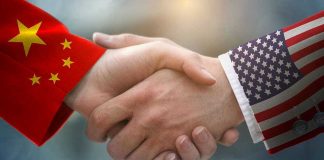 Chinese and American flag sleeves shaking hands.