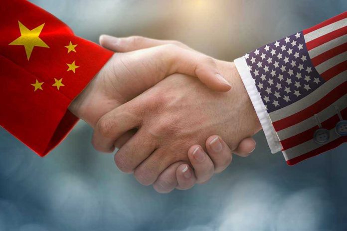 Chinese and American flag sleeves shaking hands.