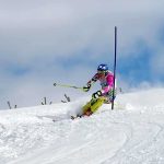 Penis Injection Doping Claim SHAKES Olympics Athlete skiing down a snowy slope around a slalom pole
