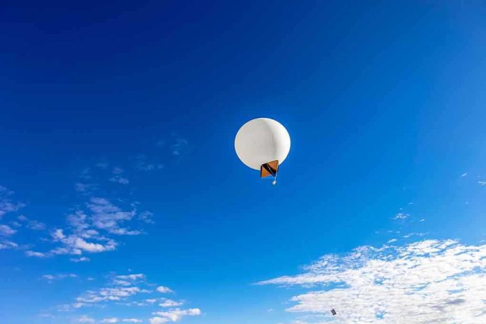 shutterstock_135903014.jpg A white balloon floating in a clear blue sky with scattered clouds