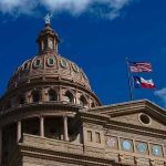 MLB Star Becomes Trump’s Texas Champion Building dome with US and Texas flags, blue sky.