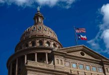 MLB Star Becomes Trump’s Texas Champion Building dome with US and Texas flags, blue sky.