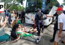 Protesters block bus believed to be carrying Iran women's