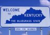 Shocking Cancer Crisis Grips Kentucky Heartland Welcome sign for Kentucky, the Bluegrass State, with a blue background