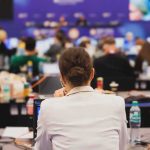 Unglamorous Jobs Win Happiness Race View of a conference room filled with attendees focused on their laptops