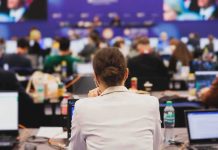View of a conference room filled with attendees focused on their laptops