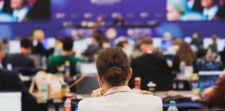 View of a conference room filled with attendees focused on their laptops