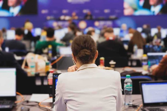 shutterstock_2478370743.jpg View of a conference room filled with attendees focused on their laptops