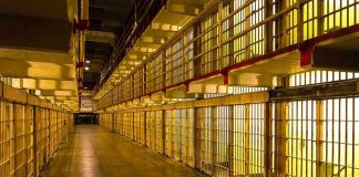 Alcatraz Reboot Shocker: $152M Down Payment Empty hallway between rows of prison cells.