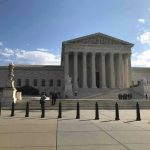 Panic Erupts Over Supreme Court Supreme Court building with flag and people outside.