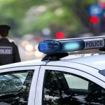 Police car and officer on a city street.