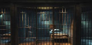 Curfew Around ICE Site — But Why Now? Empty prison cell with metal bars and bed.