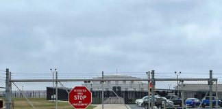 Runway Horror: Trespasser Struck by Plane! Chain-link fence with Restricted Area Stop No Photography sign.