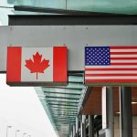 Defense Standoff: TRUMP Turns the Heat on Canada Canadian and American flags displayed at a border crossing