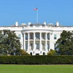 Trump’s UFC Birthday Brawl: White House Showdown The White House with the American flag flying in front