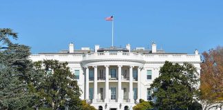 Trump’s UFC Birthday Brawl: White House Showdown The White House with the American flag flying in front