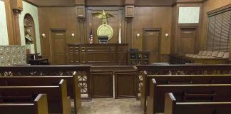 Jury Tampering BOMB – Murdaugh Murder Convictions Tossed! Interior view of an empty courtroom with wooden benches and a judges bench