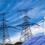 Power-Hungry Data Hubs Face Revolt Solar panels and a wind turbine with power lines against a blue sky