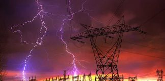 AI Merger May Skyrocket Your Power Bill Lightning strikes illuminate a power station against a colorful sunset sky