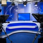 Hunter Biden Shocker: ‘Crack Addict’ Confession A television studio setup with cameras and a blue backdrop