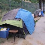 FBI Floods Skid Row — For Two Bucks? Tents and belongings set up along sidewalk.