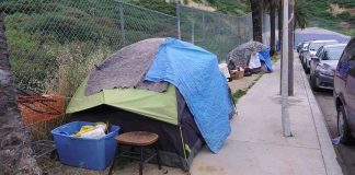 FBI Floods Skid Row — For Two Bucks? Tents and belongings set up along sidewalk.