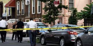 Chilling Confession—But One Victim Vanishes Police and crime scene tape on city street.