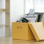 Vanity Fair Bombshell—But She’s Not Leaving? Yellow box with resignation notice on an office desk.