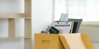 Vanity Fair Bombshell—But She’s Not Leaving? Yellow box with resignation notice on an office desk.