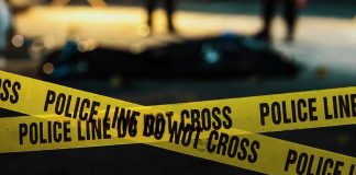 Family Massacre Stuns Iowa Town Police tape marking a crime scene at night.
