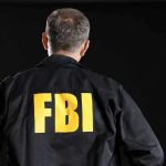 FBI agent with back facing the camera.