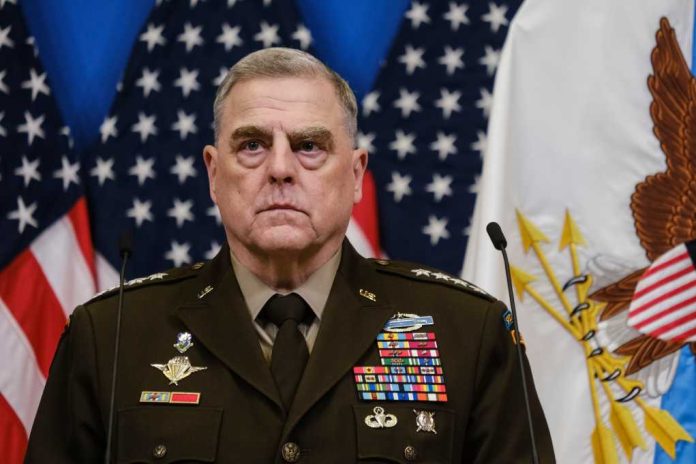 Mark-Milley-speaks_2262056569 senior military officer in uniform with medals standing before U.S. flags