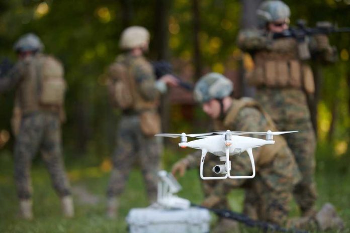 shutterstock_1807019392 A military drone being prepared for use with soldiers in the background