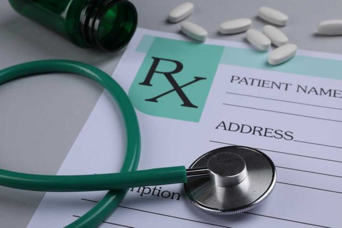 shutterstock_2446187117 A prescription pad with a stethoscope and pills nearby