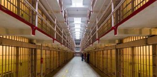Gun Grab Turns Prison Into Warzone Long hallway with prison cells on both sides.