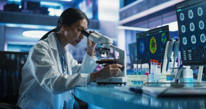 Scientist using a microscope in a modern laboratory