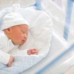 Historic Baby Shakes D.C. Norms Newborn baby sleeping in hospital bassinet